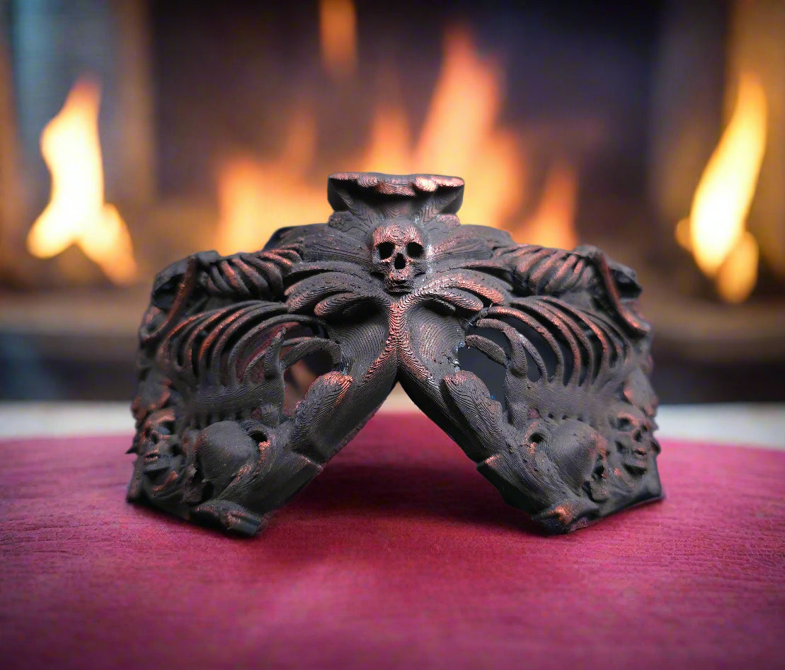A costume mask decorated in skeletons, skulls, wings, and filigree. Human ribcages cover the eyes for a false blind effect