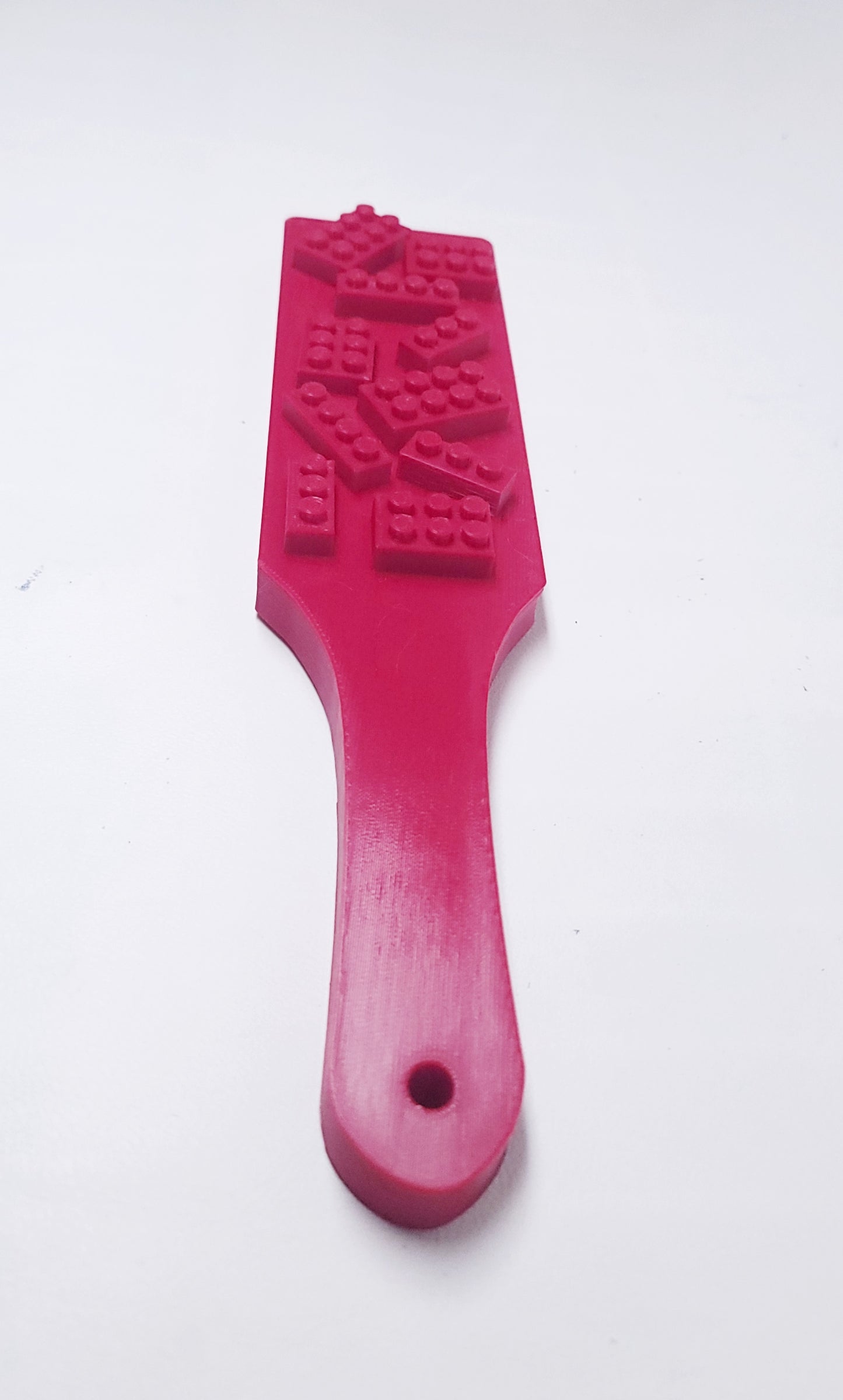 red spanking paddle with blocks