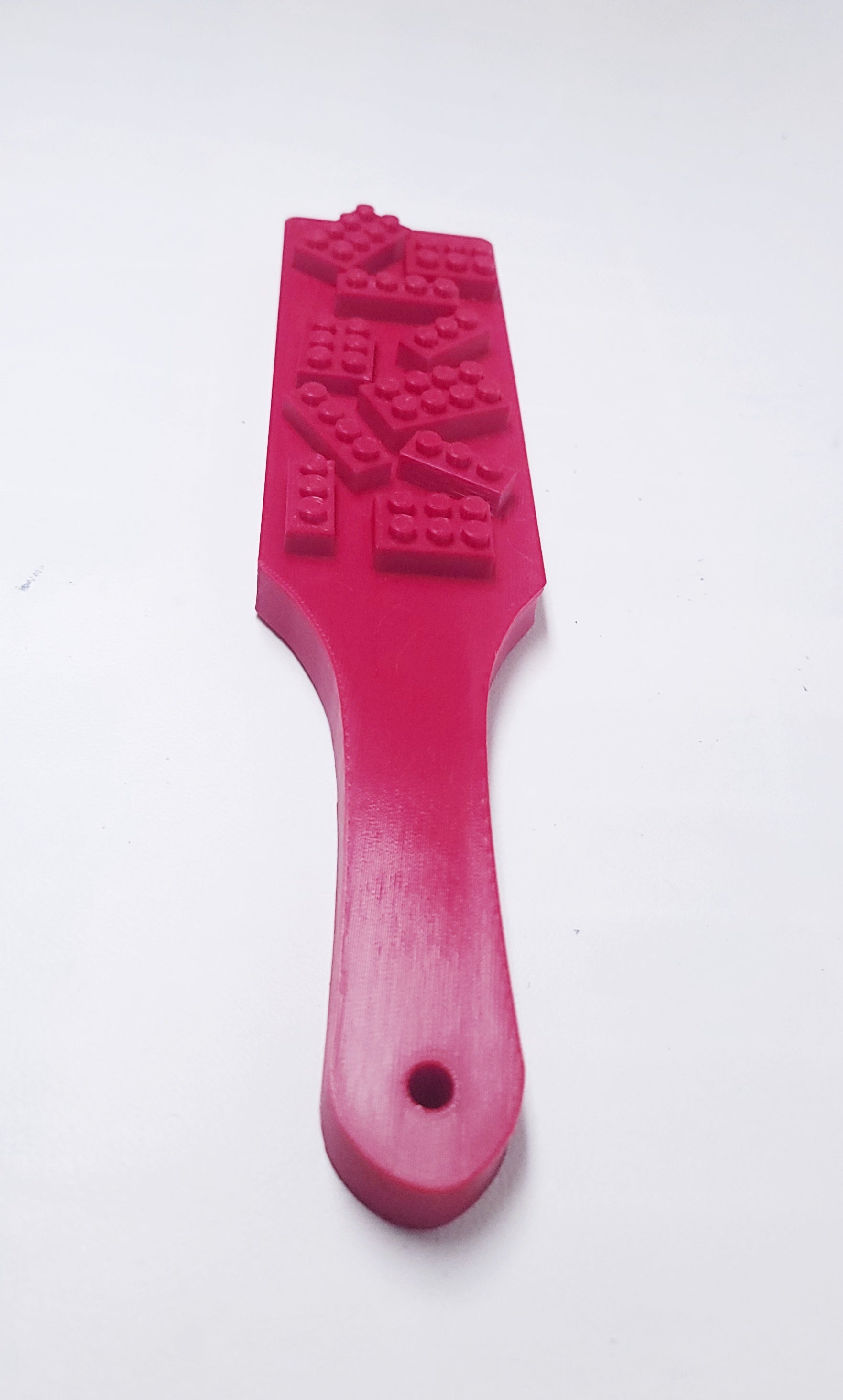 red spanking paddle with blocks