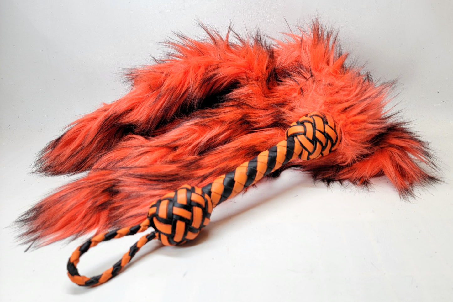 Weighted fur flogger kink toy with orange tails